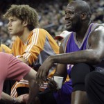 Phoenix Suns' Shaquille O'Neal, right, sits beside teammate Robin Lopez as he has his leg worked on by a trainer during the first half of an NBA basketball game against the Golden State Warriors on Sunday, March 15, 2009, in Oakland, Calif. (AP Photo/Ben Margot)