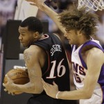 Philadelphia 76ers' Marreese Speights (16) grabs a rebound as Phoenix Suns' Robin Lopez arrives late in the second quarter of an NBA basketball game Wednesday, March 18, 2009, in Phoenix. (AP Photo/Ross D. Franklin)