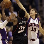 Philadelphia 76ers' Louis Williams (23) gets his shot altered by Phoenix Suns' Steve Nash (13) in the fourth quarter of an NBA basketball game Wednesday, March 18, 2009, in Phoenix. The Suns defeated the 76ers 126-116. (AP Photo/Ross D. Franklin)