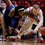 Arizona's Jordan Hill, center and Utah's Shaun Green, right and Kim Tillie, left, go after a loose ball during the first-round men's NCAA college basketball tournament game in Miami, Fla., Friday, March 20 2009. (Photo/Lynne Sladky).