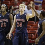 Arizona's Nic Wise, right, congratulates teammate Chase Budinger (34) after defeating Utah 84-71 during the first-round men's NCAA college basketball tournament game in Miami, Friday, March 20 2009. Arizona's Jordan Hill, left, looks on. (AP Photo/Lynne Sladky).