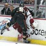 The Anaheim Ducks' Bobby Ryan pins Pheonix Coyotes' Nigel Dawes against the boards during the first period of an NHL hockey game in Anaheim, Calif., on Sunday, March 22, 2009. (AP Photo/Branimir Kvartuc)