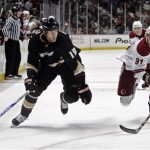 The Anaheim Ducks' Ryan Whitney, left, races the Phoenix Coyotes' Kyle Turris to the puck during the third period of an NHL hockey game in Anaheim, Calif., on Sunday, March 22, 2009. (AP Photo/Branimir Kvartuc)