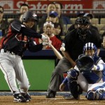 Japan's Michihiro Ogasawara hits an RBI single to score Hiroyuki Nakajima as South Korea catcher Park Kyung-oan watches at right during the third inning of the final of the World Baseball Classic in Los Angeles, Monday, March 23, 2009. (AP Photo/Matt Sayles)