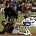 Japan's Norichika Aoki slides into second base as South Korea's Park Ki-hyuk tries to make the tag, on an attempted steal during the fifth inning of the final of the World Baseball Classic in Los Angeles, Monday, March 23, 2009. Second base umpire Ron Kulpa watches the play. Aoki then slid past the bag, and was tagged out. (AP Photo/Matt Sayles)