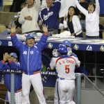 South Korea's Choo Shin-soo is greeted at the dugout after his fifth-inning homer against Japan during the championship game of the World Baseball Classic on Monday, March 23, 2009, in Los Angeles. (AP Photo/Ted S. Warren)