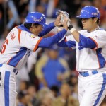 South Korea's Choo Shin-soo is congratulated by Lee Bum-ho, left, after hitting a home run during the fifth inning of the final of the World Baseball Classic, against Japan in Los Angeles, Monday, March 23, 2009. (AP Photo/Mark J. Terrill)