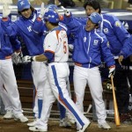 South Korea's Choo Shin-soo (5) is congratulated by teammates after his fifth-inning home run against Japan during the championship game of the World Baseball Classic Monday, March 23, 2009, in Los Angeles. (AP Photo/Ted S. Warren)