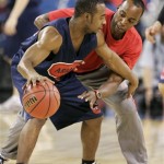 Arizona's Nic Wise, left, goes against assistant coach Reggie Geary during practice at the NCAA Midwest Regional men's college basketball tournament Thursday, March 26, 2009, in Indianapolis. Arizona plays Louisville in a regional semifinal on Friday. (AP Photo/Michael Conroy)