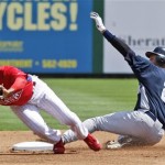 New York Yankees' Derek Jeter is safe on a stolen base in the first inning as Philadelphia Phillies shortstop Jimmy Rollins is drawn off base on the throw in the Phillies 10-2 loss to the Yankees in a spring training baseball game at Brighthouse Field in Clearwater, Fla., Thursday, March 26, 2009. (AP Photo/Kathy Willens)