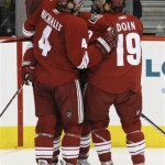 Phoenix Coyotes' Matthew Lombardi is surrounded by teammates Zbynek Michalek (4) and Shane Doan (19) after Lombardi scored against the Edmonton Oilers in the first period of an NHL hockey game in Glendale, Ariz., Thursday, March 26, 2009. (AP Photo/Aaron J. Latham)