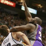 Phoenix Suns' Shaquille O'Neal, right, goes up for a rebound with Utah Jazz's Mehmet Okur, from Turkey, in the first half of an NBA basketball game in Salt Lake City on Saturday, March 28, 2009. (AP Photo/George Frey)