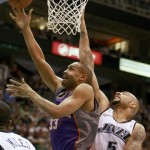 Phoenix Sun's Grant Hill, left, shoots past Utah Jazz's Carlos Boozer in the first half of an NBA basketball game in Salt Lake City, Saturday, March 28, 2009. (AP Photo/George Frey)