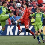 Toronto FC's Pablo Vitti, center, tries to take the ball between Seattle Sounders' Tyrone Marshall, left, and Osvaldo Alonso, right, during second-half MLS soccer game action in Toronto, Saturday, April 4, 2009. (AP Photo/The Canadian Press,Chris Young)