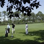 Vijay Singh, center, of Fiji practices on the driving range for the Masters golf tournament at the Augusta National Golf Club in Augusta, Ga., Monday, April 6, 2009. (AP Photo/Rob Carr)
