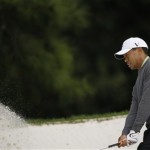 Tiger Woods chips out of a bunker during his practice round for the Masters golf tournament at the Augusta National Golf Club in Augusta, Ga., Monday, April 6, 2009. (AP Photo/Charlie Riedel)