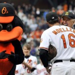 Vice President Joe Biden hugs Baltimore Orioles catcher Chad Moeller (16) after throwing out the first pitch at the Baltimore Orioles and New York Yankees opening day baseball game at Camden Yards in Baltimore, Monday, April 6, 2009. (AP Photo/Gail Burton)