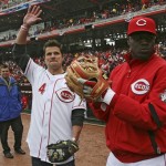 Recording artist Nick Lachey (4) waves to the crowd before throwing out the first pitch to Cincinnati Reds' Brandon Phillips, right, prior to a baseball game between the Reds and the New York Mets, Monday, April 6, 2009, in Cincinnati. (AP Photo/Tom Uhlman)