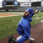 Kansas City Royals catcher Miguel Olivo throws at US Cellular Field after their baseball game with the Chicago White Sox was postponed until Tuesday due to snow in Chicago, Monday, April 6, 2009. (AP Photo/Charles Rex Arbogast)