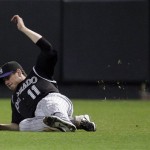 Colorado Rockies' Brad Hawpe (11) makes a diving catch on a ball hit by Arizona Diamondbacks' Doug Davis to end the second inning in an MLB baseball game Wednesday, April 8, 2009, in Phoenix. (AP Photo/Ross D. Franklin)