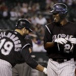 Colorado Rockies' Dexter Fowler, right, smiles after getting a high-five from teammate Ryan Spilborghs (19) after Fowler's hit a home run against the Arizona Diamondbacks in the first inning of a baseball game, Wednesday, April 8, 2009, in Phoenix. (AP Photo/Ross D. Franklin)