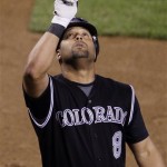 Colorado Rockies' Yorvit Torrealba (8), of Venezuela, points up after crossing home plate after hitting a home run against the Arizona Diamondbacks in the seventh inning of a baseball game Wednesday, April 8, 2009, in Phoenix. (AP Photo/Ross D. Franklin)