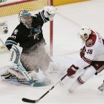 San Jose Sharks goalie Evgeni Nabokov, of Kazakhstan, left, stops a shot from Phoenix Coyotes left wing Joakim Lindstrom, of Sweden, during the first period of an NHL hockey game in San Jose, Calif.Thursday, April 9, 2009. (AP Photo/Marcio Jose Sanchez)
