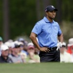 Tiger Woods watches his shot over the green on the 12th hole during the second round of the Masters golf tournament at the Augusta National Golf Club in Augusta, Ga., Friday, April 10, 2009. (AP Photo/Charlie Riedel)