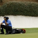 Tiger Woods sits on his bag at the 12th green during the second round of the Masters golf tournament at the Augusta National Golf Club in Augusta, Ga., Friday, April 10, 2009. (AP Photo/Charlie Riedel)