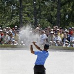 Tiger Woods hits out of a bunker on the ninth hole during the second round of the Masters golf tournament at the Augusta National Golf Club in Augusta, Ga., Friday, April 10, 2009. (AP Photo/Rob Carr)