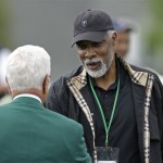 Former basketball player Julius Irving talks to a member of the Augusta National Golf Club during the second round of the Masters golf tournament in Augusta, Ga., Friday, April 10, 2009. (AP Photo/Rob Carr)