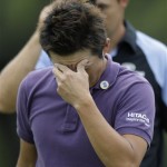 Ryuji Imada of Japan holds his head after finishing his second round of the Masters golf tournament at the Augusta National Golf Club in Augusta, Ga., Friday, April 10, 2009. (AP Photo/Rob Carr)