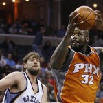 Phoenix Suns center Shaquille O'Neal (32) muscles his way to the basket against Memphis Grizzlies forward Marc Gasol, left, of Spain, in the first half of an NBA basketball game Friday, April 10, 2009, in Memphis, Tenn. (AP Photo/Lance Murphey)