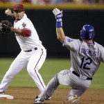 Arizona Diamondbacks second baseman Felipe Lopez, left, throws to first after forcing out Los Angeles Dodgers' Brad Ausmus to complete a double play in the second inning of a baseball game Friday, April 10, 2009, in Phoenix. (AP Photo/Paul Connors)
