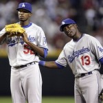 Los Angeles Dodgers pitcher James McDonald, left, is patted on the back by teammate Orlando Hudson after McDonald gave up a two-run single to Arizona Diamondbacks' Conor Jackson, not shown, in the third inning of a baseball game Friday, April 10, 2009, in Phoenix. McDonald was pulled from the game after allowing five runs in two and two-thirds innings. (AP Photo/Paul Connors)
