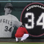 Los Angeles Angels starting pitcher Jered Weaver pays his respect at a center field banner of Los Angeles Angels rookie pitcher Nick Adenhart who was killed early Thursday in an auto accident in Fullerton, Calif., before their baseball game with the Boston Red Sox in Anaheim, Calif., Friday, April 10, 2009. (AP Photo/Chris Carlson)