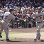 Los Angeles Dodgers' Russell Martin, left, congratulates teammate Rafael Furcal, right, after Furcal scored on a single by James Loney against the Arizona Diamondbacks in the third inning of a baseball game Sunday, April 12, 2009, in Phoenix. The Dodgers won 3-1. (AP Photo/Paul Connors)