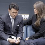 As a video tribute plays, Oscar De La Hoya sits with his wife Millie before he announces his retirement from boxing in a news conference in Los Angeles Tuesday, April 14, 2009. (AP Photo/Reed Saxon)