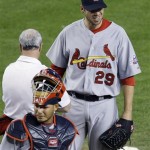 St. Louis Cardinals' Chris Carpenter (29) grimaces as head trainer Barry Weinberg examines him while catcher Yadier Molina looks away during a baseball game against the Arizona Diamondbacks' prior to the bottom of the fourth inning Tuesday, April 14, 2009, in Phoenix. (AP Photo/Ross D. Franklin)