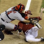 St. Louis Cardinals' Yadier Molina, left, tags out Arizona Diamondbacks' Stephen Drew trying to score on an infield ground ball in the ninth inning of a baseball game Tuesday, April 14, 2009, in Phoenix. Umpire Jim Reynolds looks on at bottom left. (AP Photo/Ross D. Franklin)