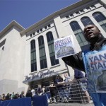 Zavien Keller sells programs outside the new Yankee Stadium before the first regular season baseball game on Thursday, April 16, 2009, in New York. The Yankees face the Cleveland Indians in their home opener. (AP Photo/Seth Wenig)