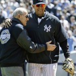 Former New York Yankees catcher and Hall of Famer Yogi Berra, left, is embraced by Yankees catcher Jose Molina after throwing out the ceremonial first pitch at the first regular season baseball game at the new Yankee Stadium on Thursday, April 16, 2009, in New York. The Yankees face the Cleveland Indians in their home-opener. (AP Photo/Julie Jacobson)