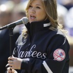 Kelly Clarkson sings the national anthem before the first regular season baseball game at the New Yankee Stadium on Thursday, April 16, 2009, in New York. The Yankees face the Cleveland Indians in their home-opener. (AP Photo/Julie Jacobson)