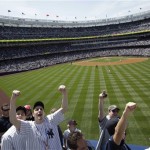 Fans cheer at the first regular season baseball game at the new Yankee Stadium on Thursday, April 16, 2009, in New York. The Yankees face the Cleveland Indians in their home-opener. The new stadium has a decidedly upstairs-downstairs feel that grates on critics who see it as catering to rich and famous - but opening day fans may not really care. (AP Photo/Seth Wenig)
