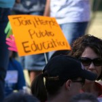 Teachers and students hold up signs to protest cuts to Arizona's education system. About 150 people showed up to the rally. (Jim Cross/KTAR) 