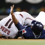 San Diego Padres Henry Blanco, right, signals for time after getting tangled up with Arizona Diamondbacks shortstop Augie Ojeda, left, during the fifth inning of a baseball game Wednesday, May 6, 2009 in San Diego. Blanco was safe on the play. (AP Photo/Denis Poroy)