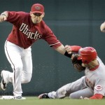 Cincinnati Reds' Jerry Hairston Jr., right, slides safely into second base as Arizona Diamondbacks' Augie Ojeda tries to apply the tag during the first inning of a baseball game in Phoenix, Tuesday, May 12, 2009. (AP Photo/Matt York)