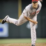 Cincinnati Reds pitcher Micah Owings follows through on a pitch against the Arizona Diamondbacks during the first inning of a baseball game in Phoenix, Tuesday, May 12, 2009. (AP Photo/Matt York)