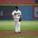 Florida Marlins second baseman Dan Uggla stands in the heavy rain during the second inning of a baseball game against the Arizona Diamondbacks in Miami, Monday, May 18, 2009. (AP Photo/J Pat Carter)