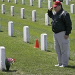 Mike Belmessieri, of South San Francisco, salutes in front of the grave of U.S. Marine Michael Bianchini at the Golden Gate National Cemetery, where over 100,000 U.S. war veterans are buried, in San Bruno, Calif., Friday, May 22, 2009. Binachini died serving in Vietnam. Belmessieri, himself a former Marine, is active in promoting causes for veterans. His son Dominic Belmessieri is a U.S. Marine about to be deployed to Afghanistan after two tours in Iraq. (AP Photo/Marcio Jose Sanchez)